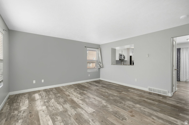 7936 Wycliffe Way Eagle Mountain, UT 84005 - Photo 6 of 37 Spare room with dark wood-type flooring and baseboards