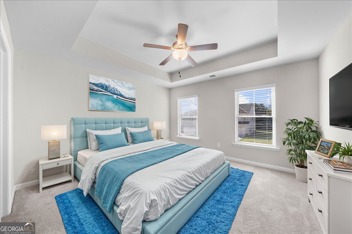 220 Harrison Street Calhoun, GA 30701 - Photo 11 of 17 a spacious bedroom with a large bed and a chandelier