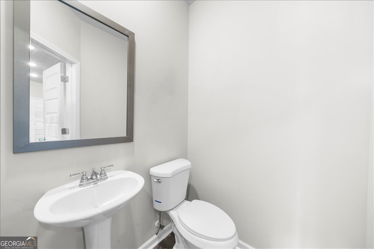 220 Harrison Street Calhoun, GA 30701 - Photo 14 of 17 a bathroom with a sink a mirror and a toilet