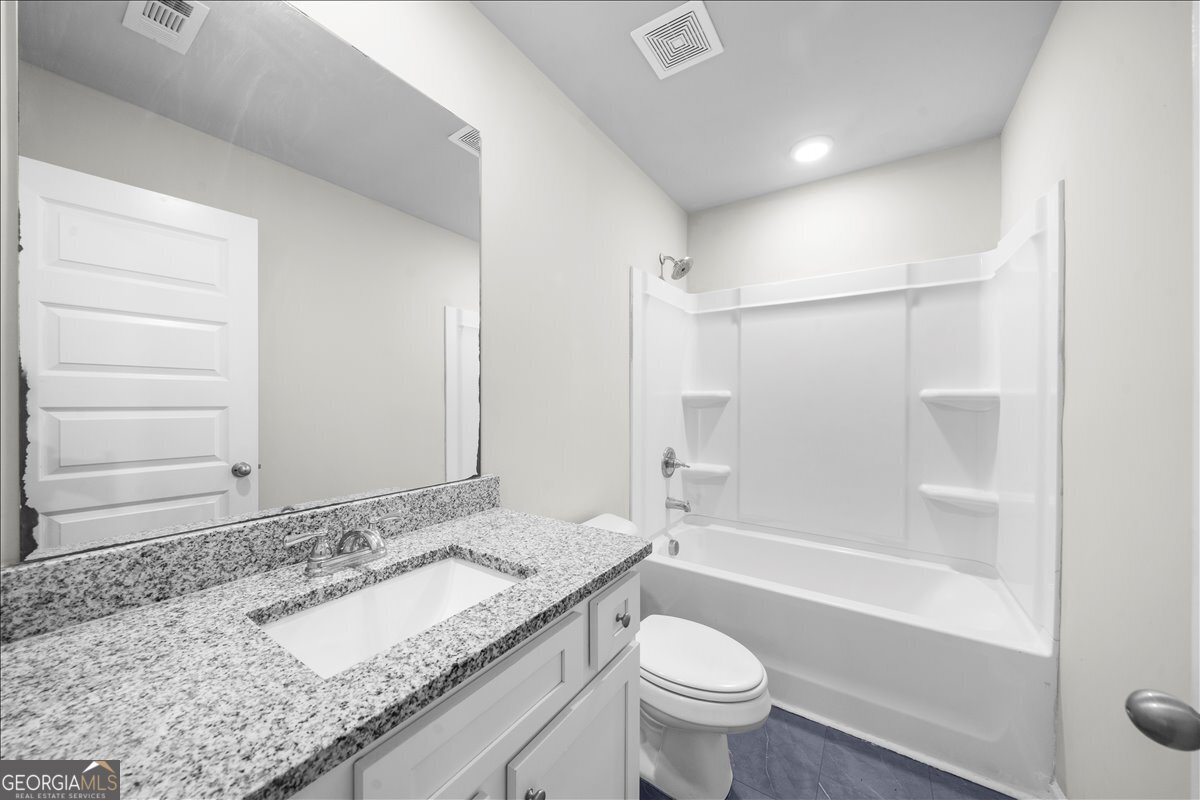 220 Harrison Street Calhoun, GA 30701 - Photo 16 of 17 a bathroom with a granite countertop sink toilet and shower