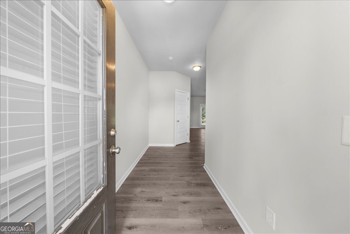 220 Harrison Street Calhoun, GA 30701 - Photo 2 of 17 a view of a hallway with wooden floor and staircase