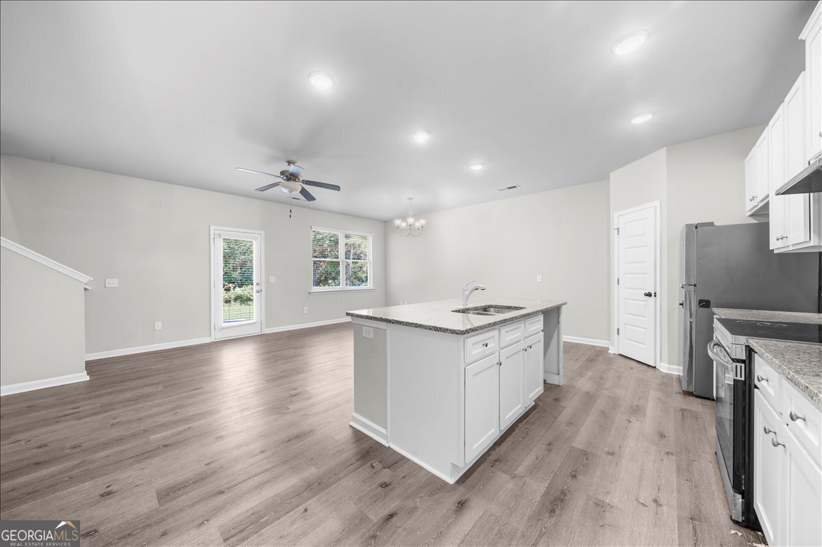220 Harrison Street Calhoun, GA 30701 - Photo 5 of 17 a kitchen with sink stove and cabinets