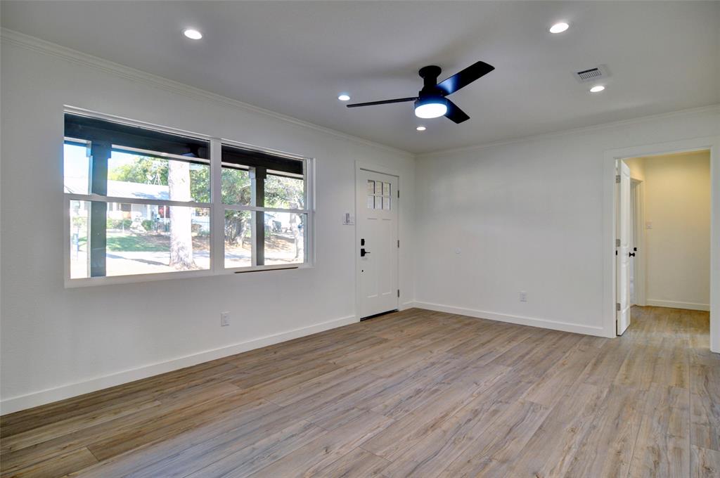 5549 Sam Calloway Road Fort Worth, TX 76114 - Photo 8 of 31 a view of an empty room with wooden floor and a window
