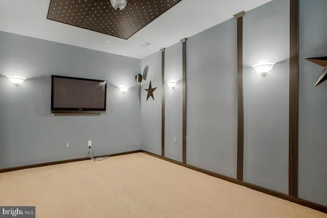 a view of a dining room with furniture a chandelier and a rug