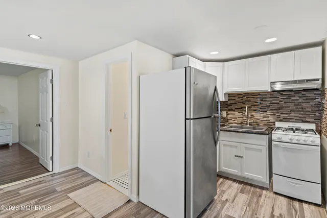 a kitchen with stainless steel appliances a refrigerator and a stove top oven