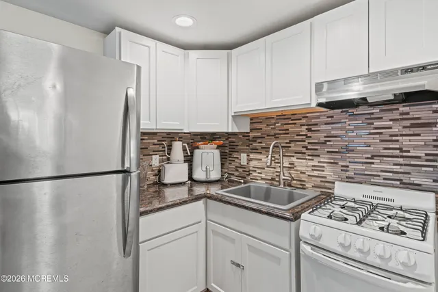 a kitchen with a refrigerator and a stove