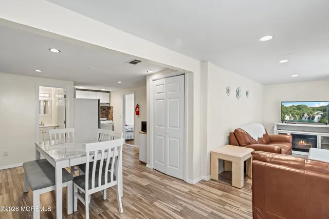 a view of a dining room with furniture and a flat screen tv