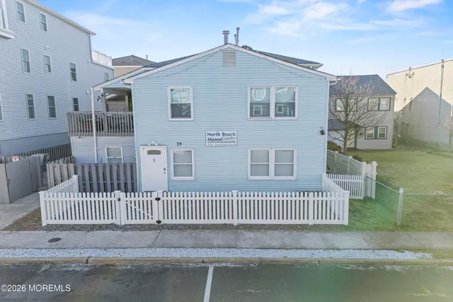 a front view of a house with a fence