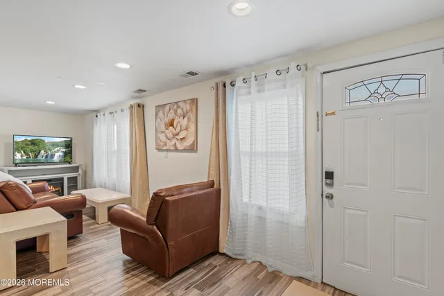 a living room with furniture a couch and a window