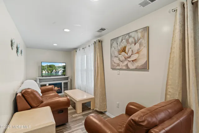 a living room with furniture a couch and a window