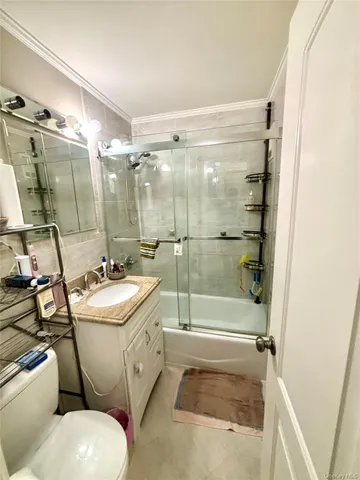 a bathroom with a sink and mirror with toilet