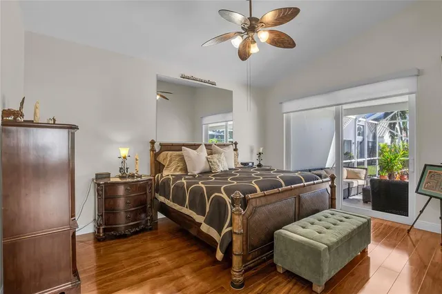 a bedroom with bed and wooden floor