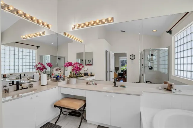 a bathroom with a sink double vanity and a mirror