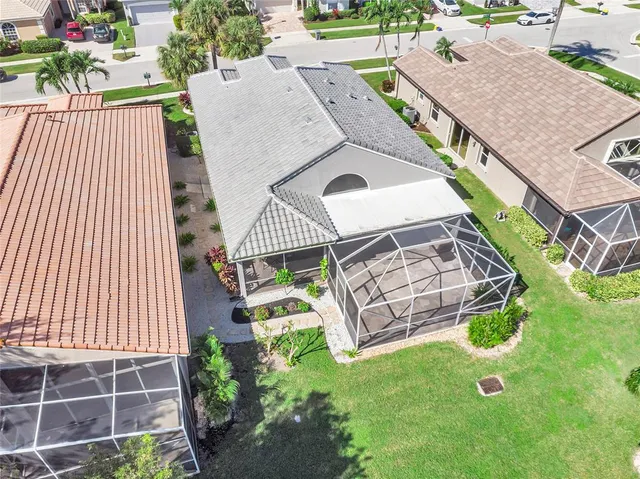an aerial view of a house with garden space and street view