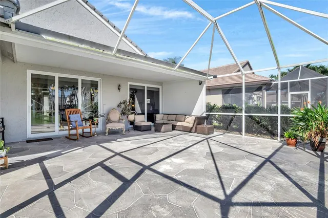 a view of a patio with table and chairs potted plants with wooden floor