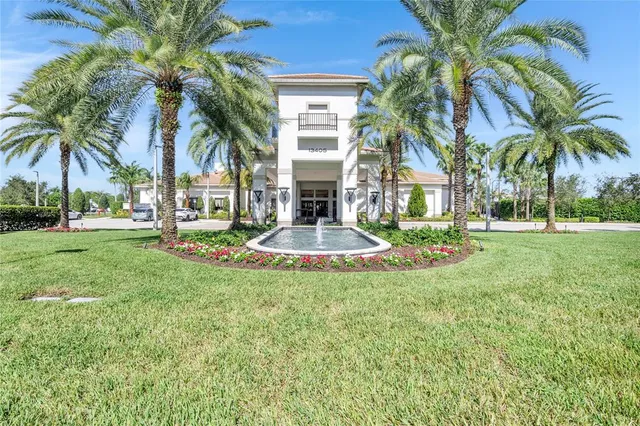 a view of a house with a yard and palm trees