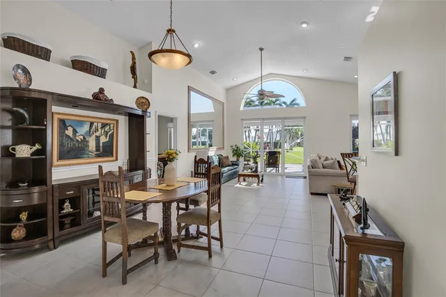 a view of a livingroom and a dining room with furniture window and wooden floor