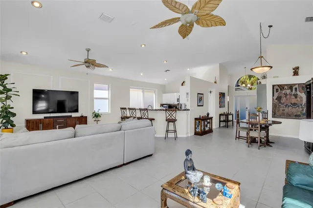 a living room with furniture a window and a flat screen tv
