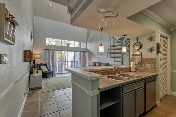 a kitchen with a stove a sink and cabinets