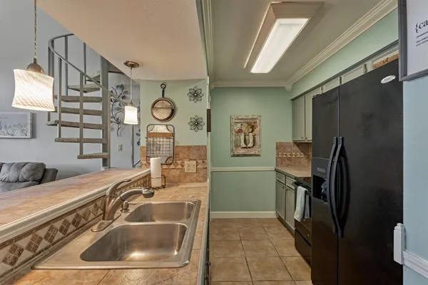 a kitchen with a sink and a refrigerator