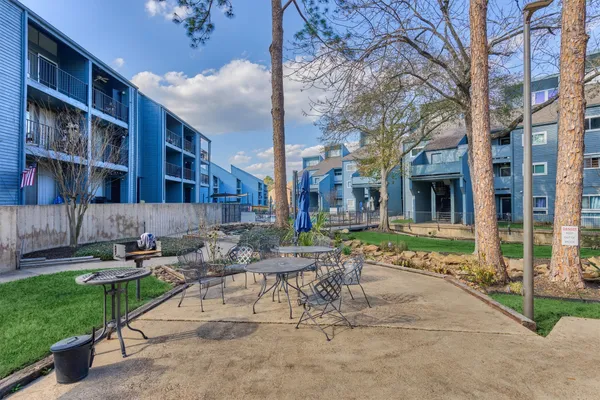a view of a patio with chairs and tables in the patio