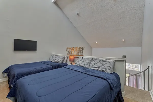 a bedroom with a bed and a flat screen tv