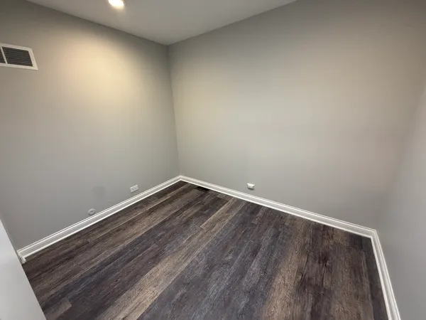 a room with wooden floor and natural light