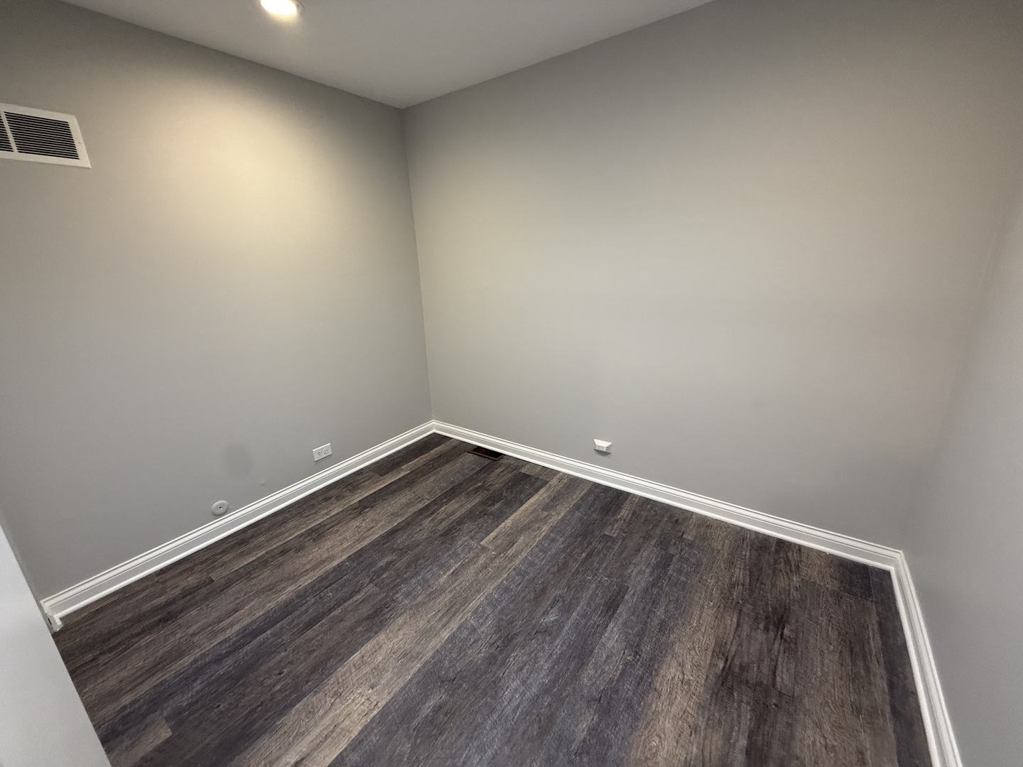 744 West Gordon Terrace, Unit 303 Chicago, IL 60613 - Photo 12 of 14 a room with wooden floor and natural light