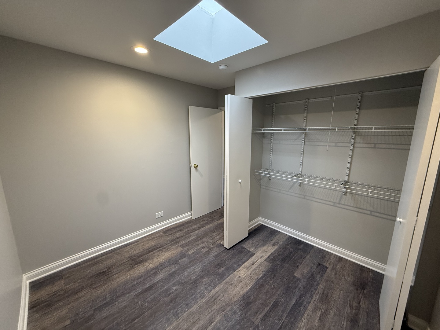 744 West Gordon Terrace, Unit 303 Chicago, IL 60613 - Photo 13 of 14 an empty room with wooden floor and cabinet