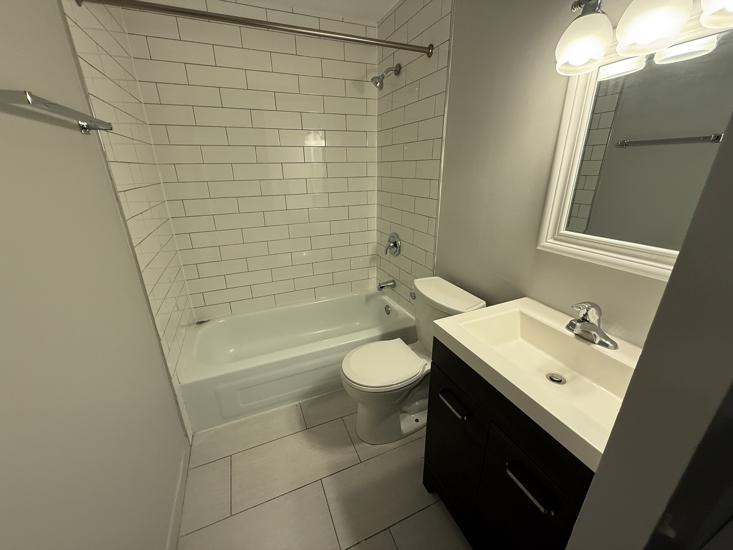 744 West Gordon Terrace, Unit 303 Chicago, IL 60613 - Photo 14 of 14 a bathroom with a sink a toilet and shower