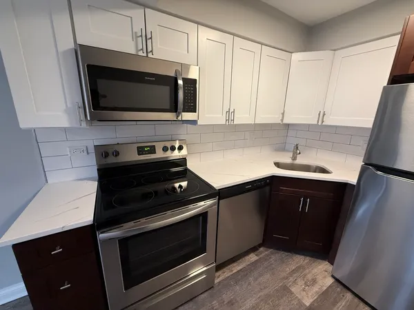 a kitchen with a sink stove and microwave