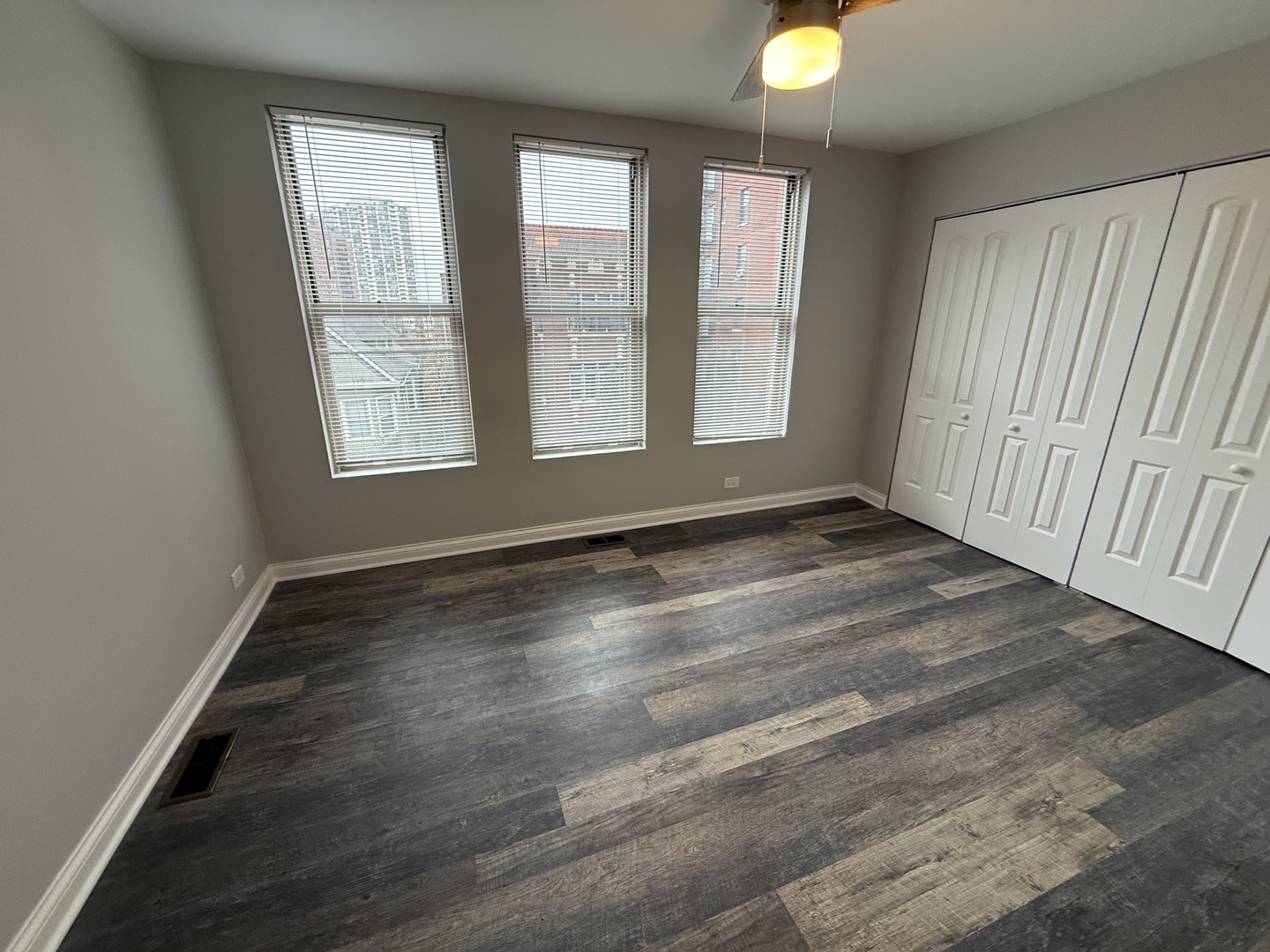 744 West Gordon Terrace, Unit 303 Chicago, IL 60613 - Photo 10 of 14 an empty room with wooden floor and windows