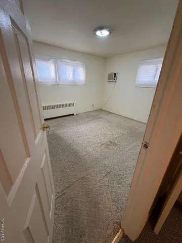 a bathroom with a sink toilet and window
