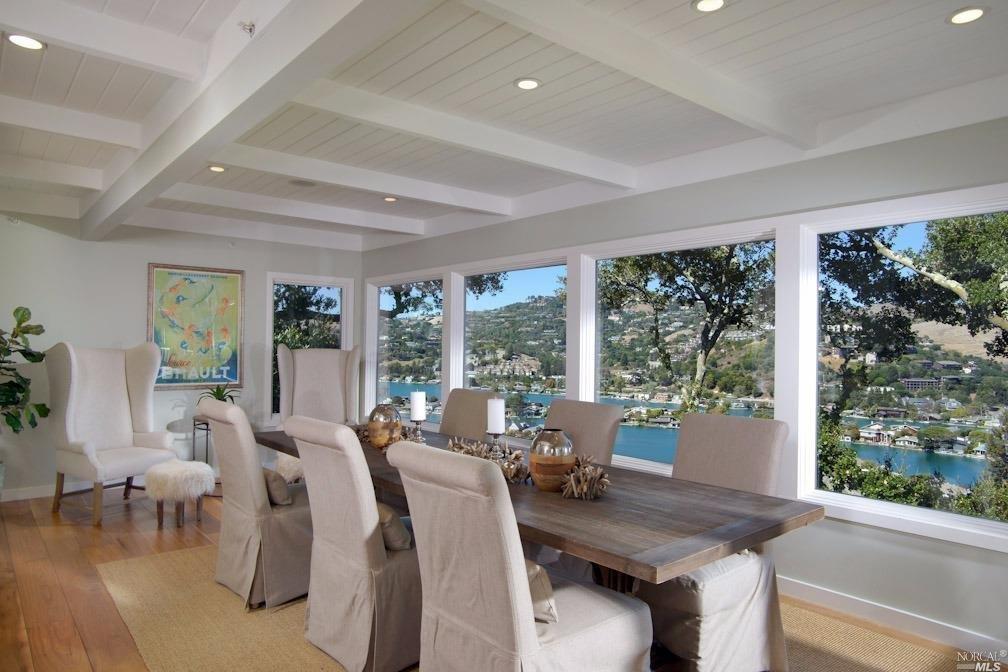 a view of a dining room with furniture large windows and wooden floor