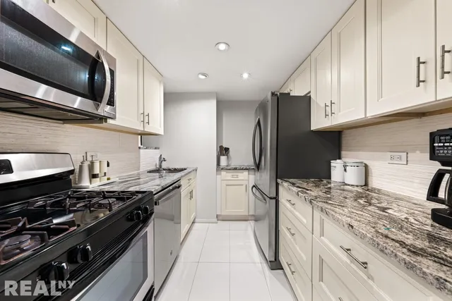 a view of a dining room with furniture a chandelier and wooden floor