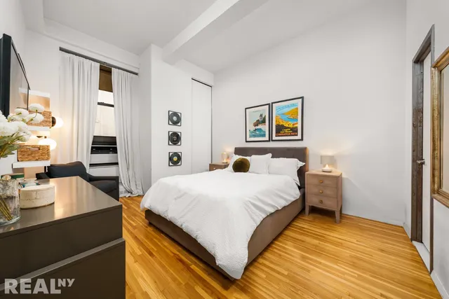 a living room with furniture a rug and a window