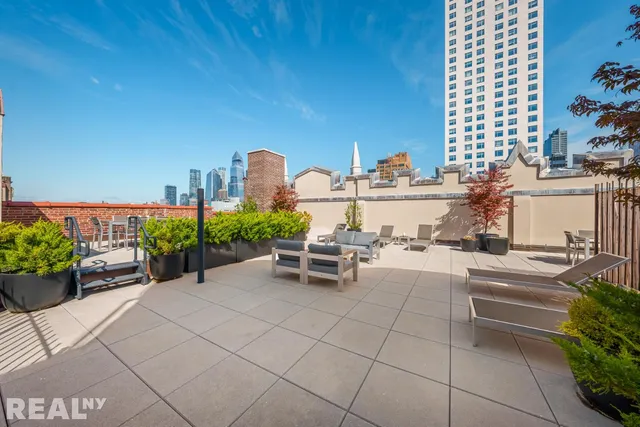 a bathroom with a granite countertop sink mirror vanity bathtub and a toilet