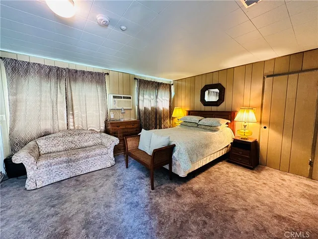 a bedroom with furniture and a large window