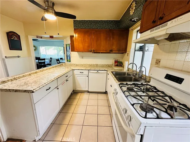 a kitchen with stainless steel appliances kitchen island granite countertop a sink and cabinets