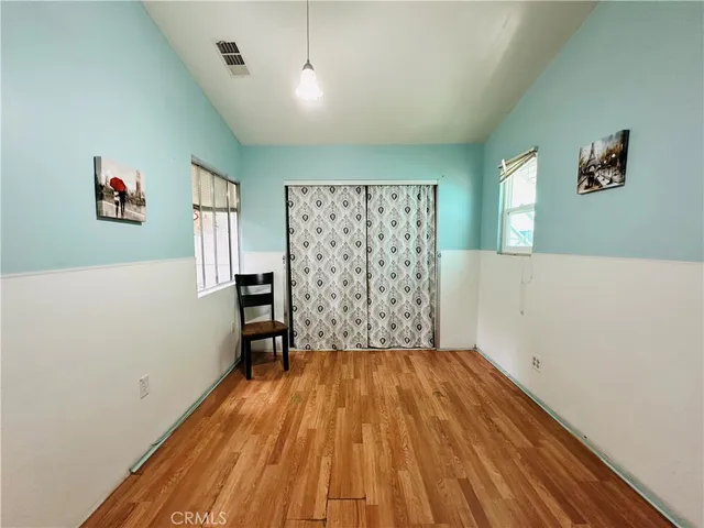 a bedroom with a bed and a tv