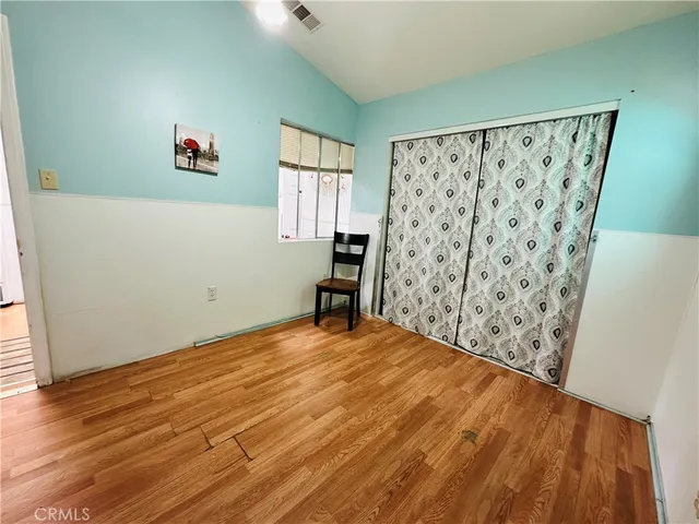 a bedroom with a bed and a couch