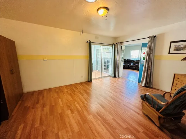 a bedroom with a bed a mirror and a window