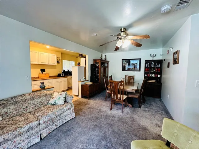 a living room with furniture fireplace and a large window