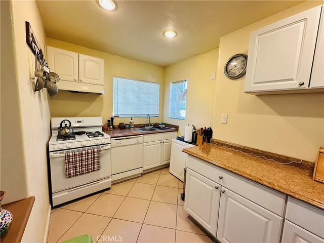 a kitchen with a sink cabinets and appliances