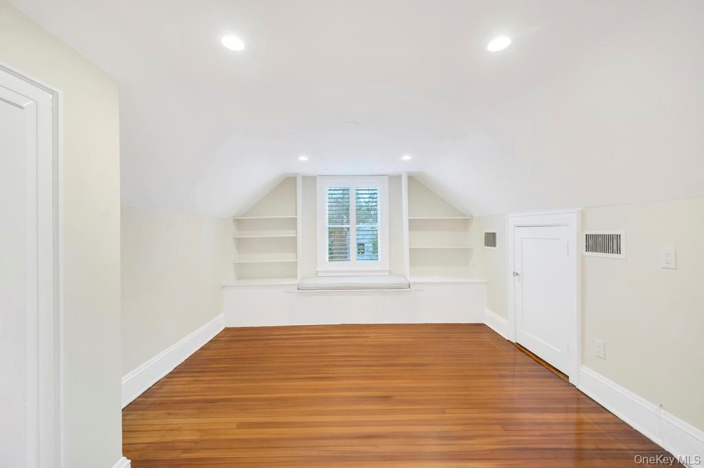 9 Sycamore Drive Great Neck, NY 11021 - Photo 35 of 49 a view of an empty room with wooden floor and a window