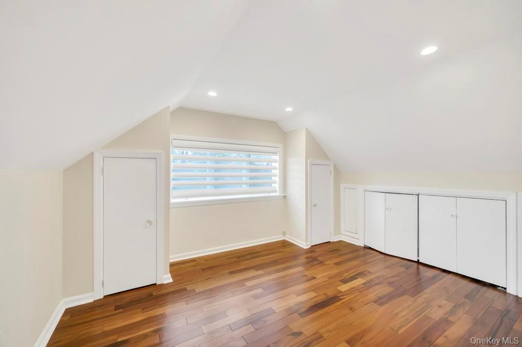 9 Sycamore Drive Great Neck, NY 11021 - Photo 38 of 49 an empty room with wooden floor and windows