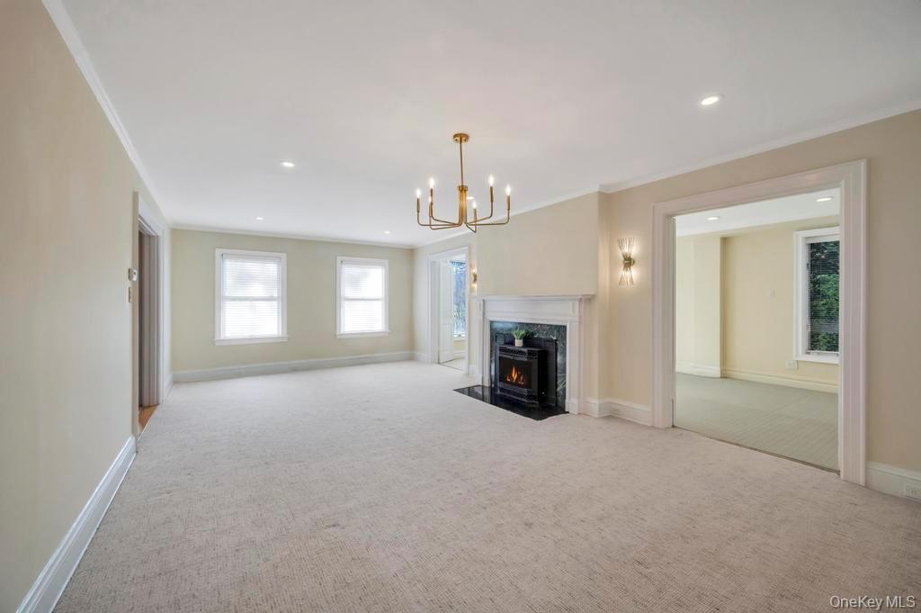 9 Sycamore Drive Great Neck, NY 11021 - Photo 4 of 49 a view of an empty room with a fireplace and a window