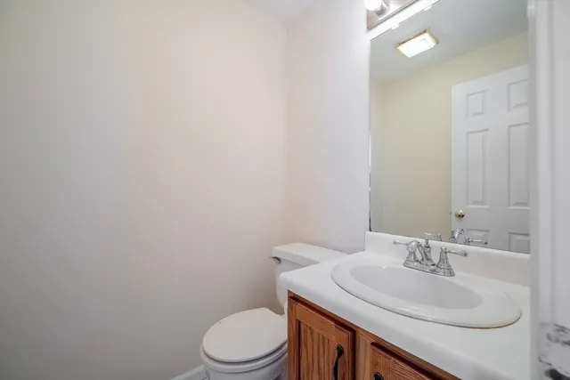 a bathroom with a sink a toilet and a mirror