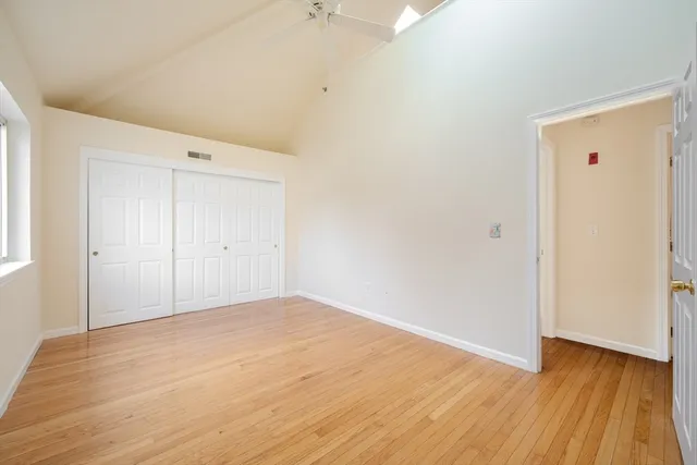 a view of an empty room with wooden floor