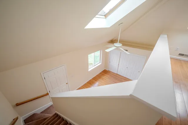 a view of a room with stairs and a ceiling fan